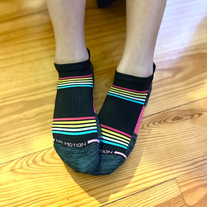 Ankle compression socks with colorful stripes, featuring a black base and a logo on the toe area.