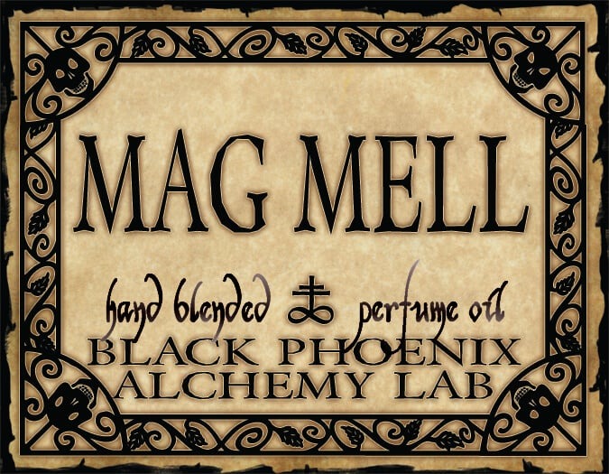 Label for 'Mag Mell' hand blended perfume oil by Black Phoenix Alchemy Lab with decorative border.