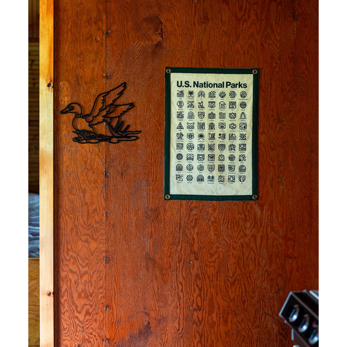 Forager Provisions LTD Oxford Pennant National Parks wool felt camp flag with Steve Wolf graphic hanging on wood wall