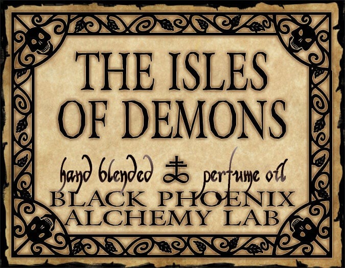 Label for 'The Isles of Demons' perfume oil by Black Phoenix Alchemy Lab with decorative border.