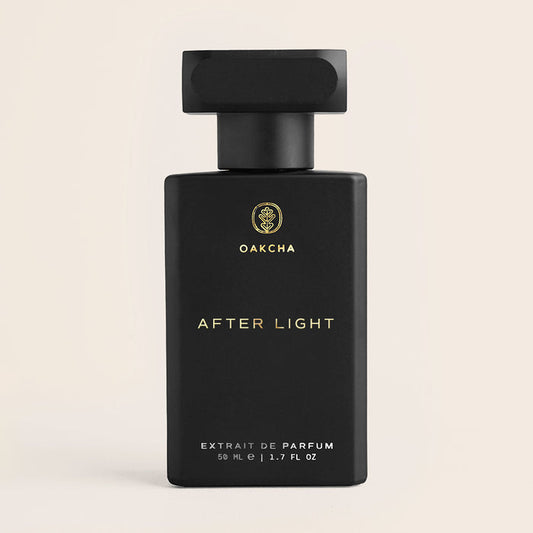 Front view After Light perfume bottle matte black bottle with gold Oakcha logo and AFTER LIGHT label on beige background