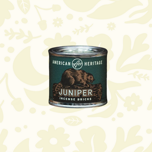 Forager Provisions LTD American Heritage Brands Juniper incense bricks in a green tin resting on vintage books.
