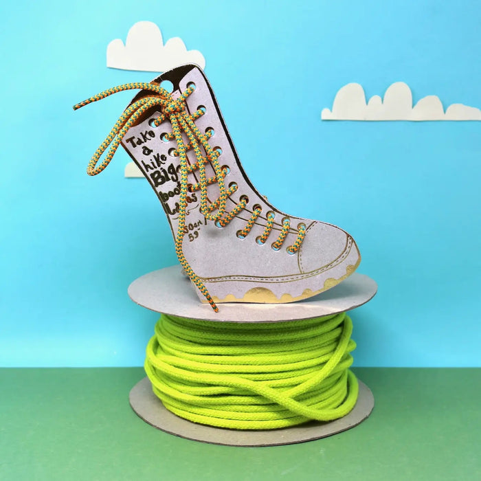 Forager Provisions LTD Ark Colour Design orange and green patterned boot laces on a spool with a cardboard boot display