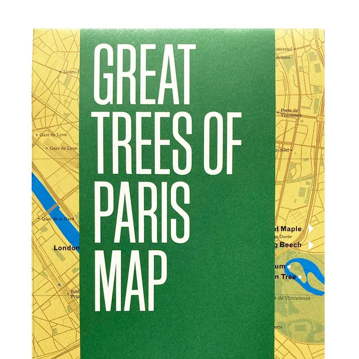 Cover of the Blue Crow Media Great Trees Of Paris Map, featuring a green band and a partial view of a yellow map in the background, printed on recycled paper.