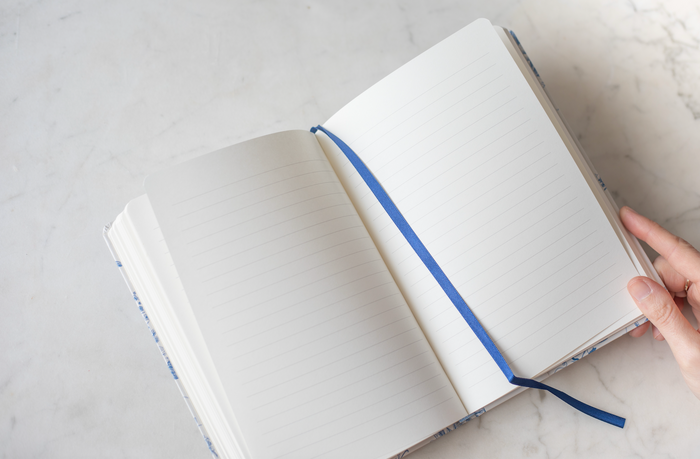 Open notebook with a blue ribbon.