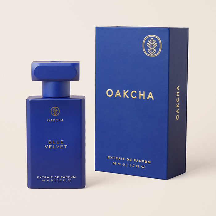 Front view of Blue Velvet 50ml bottle and box showcasing matte blue finish and gold Oakcha logo on beige background