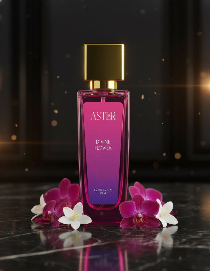 Pink and purple perfume bottle with gold cap on a dark surface with flowers