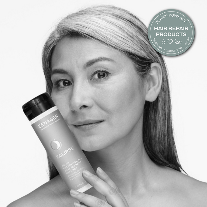 Lifestyle image of a model holding Zenagen Eclipse shampoo, showcasing healthy-looking hair with natural shine and smooth texture appearance.