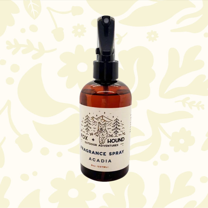 Forager Provisions LTD Fox + Hound Acadia dog cologne in an 8oz amber spray bottle against a festive holiday background.
