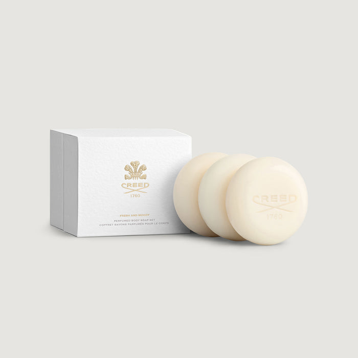 Three ivory Creed 1760-embossed soaps beside white gift box - Fresh & Woody Perfumed Soap Set | Creed Boutique