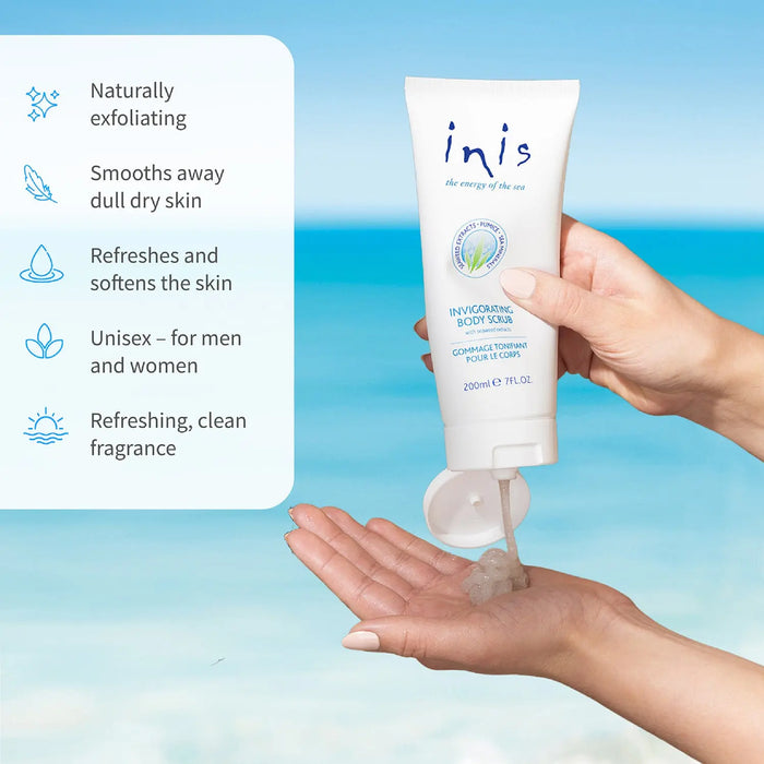 Hand holding a tube of 'inis' body scrub against a blue gradient background.