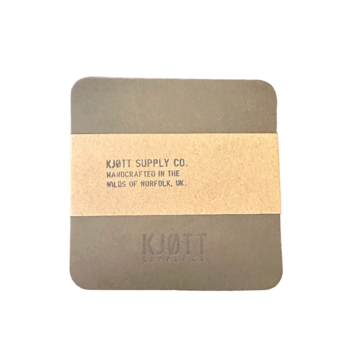 Forager Provisions LTD khaki green vegetable-tanned leather coasters with Kjøtt Supply Co. branding and paper wrap