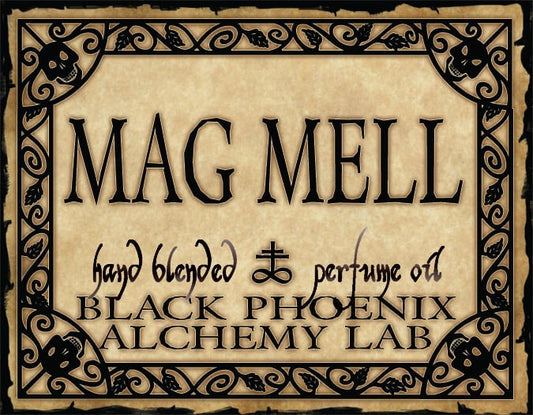 Label for 'Mag Mell' hand blended perfume oil by Black Phoenix Alchemy Lab with decorative border.