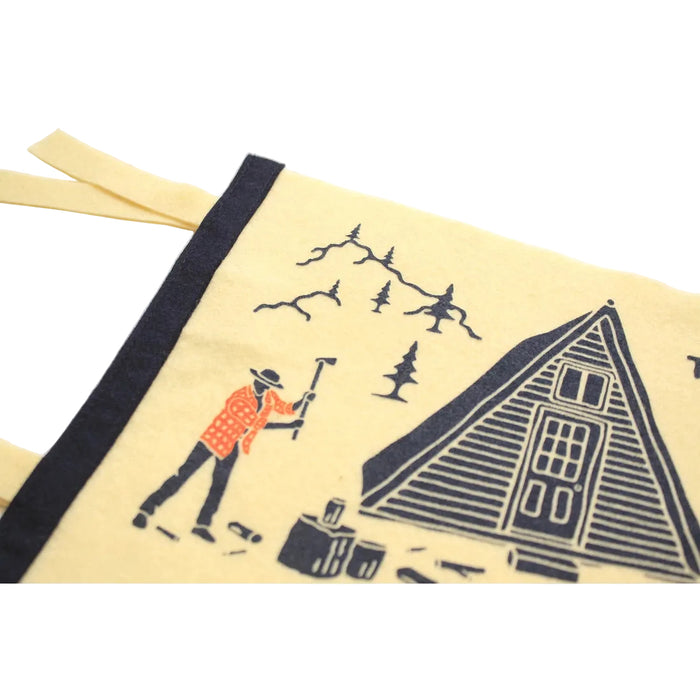 A yellow Oxford Pennant "No Substitute For Hard Work" custom pennant, made from wool felt, features an illustration of a cabin, trees, mountains, and a person with the text "There is no substitute for hard work.
