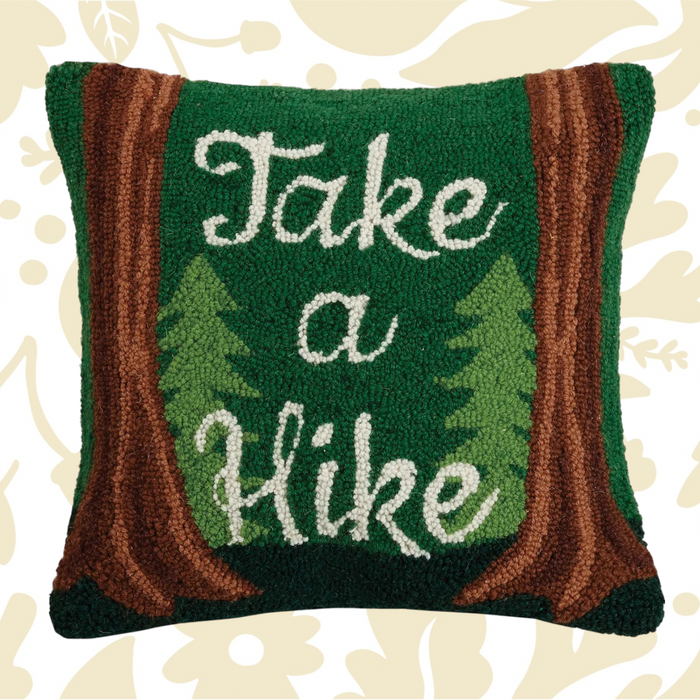 The Peking Handicraft Take A Hike Wool Hook Cushion is a green 16x16" throw pillow featuring tree designs and brown borders, with the text "Take a Hike" in white, crafted in a hooked wool style.
