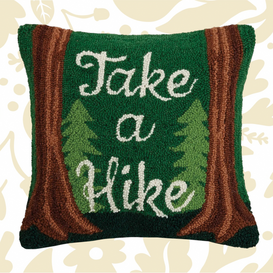 The Peking Handicraft Take A Hike Wool Hook Cushion is a green 16x16" throw pillow featuring tree designs and brown borders, with the text "Take a Hike" in white, crafted in a hooked wool style.