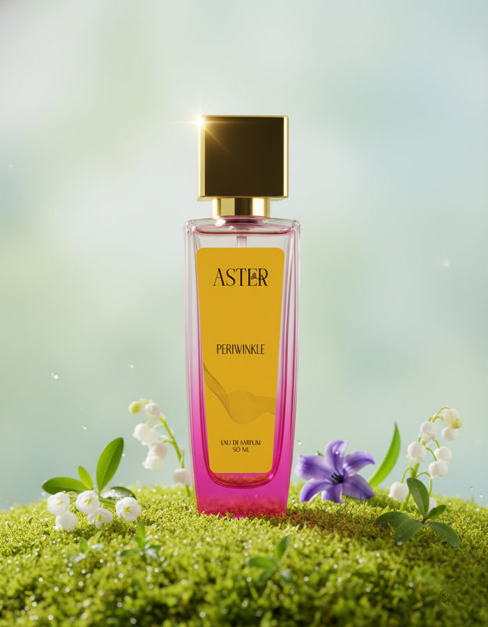 Perfume bottle labeled 'Aster' on a grassy background with flowers