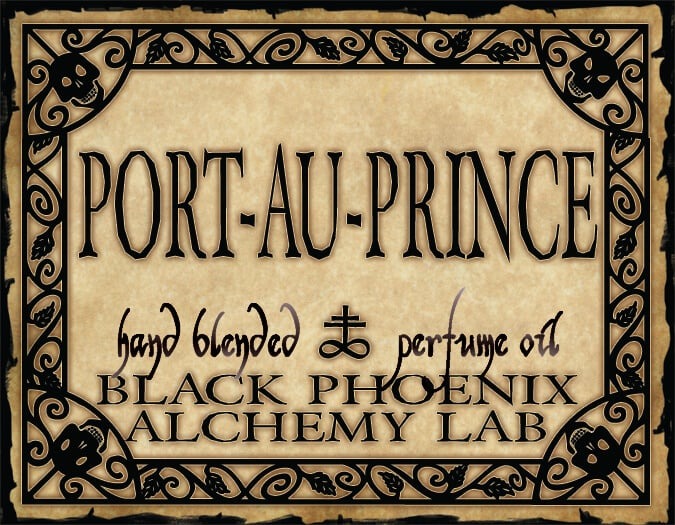 Label for 'Port-Au-Prince' perfume oil by Black Phoenix Alchemy Lab with decorative border.