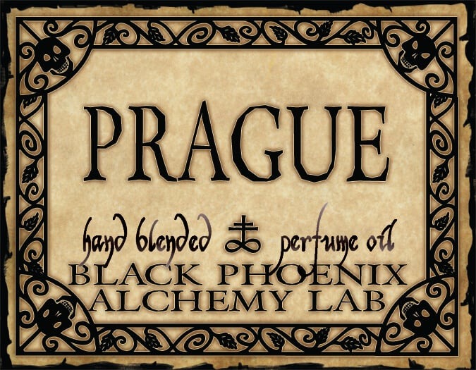 Label for 'Prague' hand blended perfume oil by Black Phoenix Alchemy Lab with decorative border.