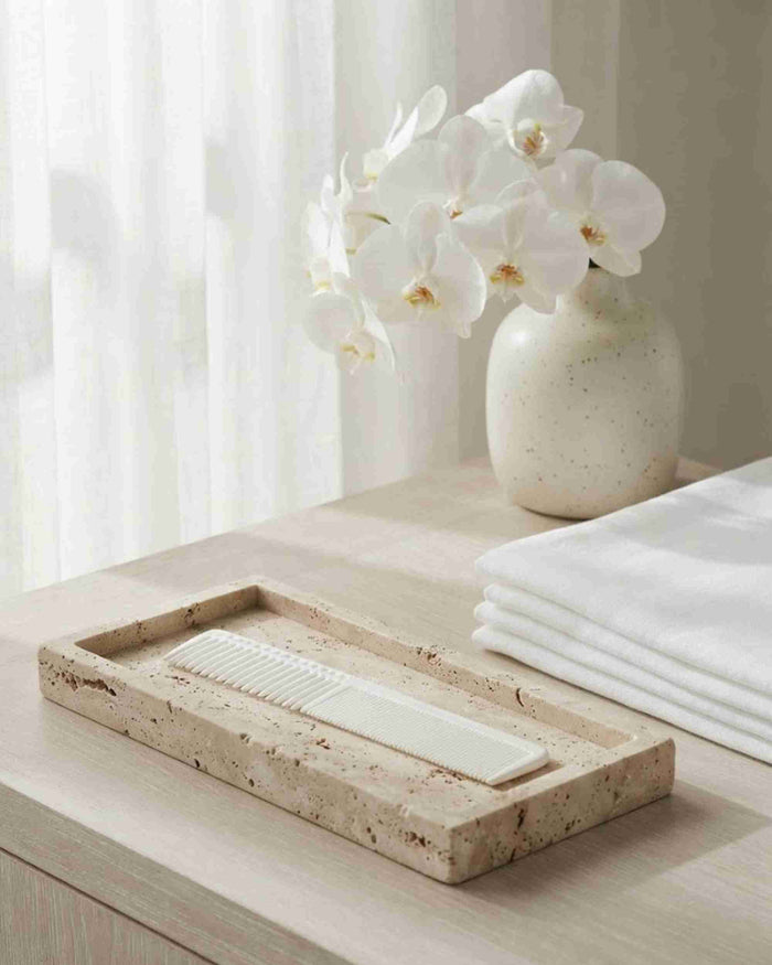 Long hair comb lying in a speckled tray, fine teeth for detangling