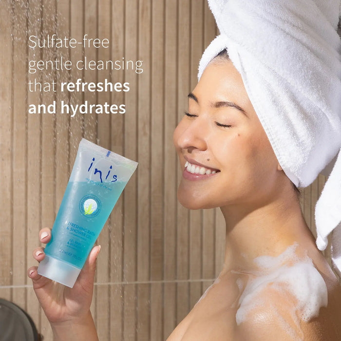 Woman with a towel on her head holding a blue tube of skincare product, with text about sulfate-free cleansing.