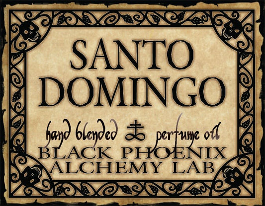 Label for Santo Domingo hand blended perfume oil by Black Phoenix Alchemy Lab with decorative border.