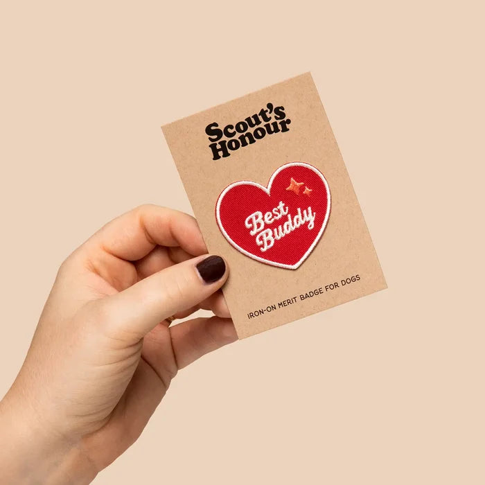 Hand holding red Scout’s Honour Best Buddy Dog Patch card, featuring Scout’s Honour brand logo for dog lovers and pet owners.