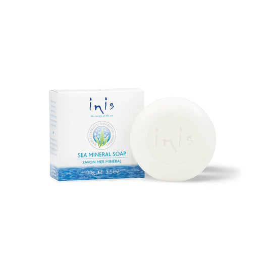 A round soap bar of Inis Sea Mineral Soap next to its white and blue packaging box, set against a clean white background.