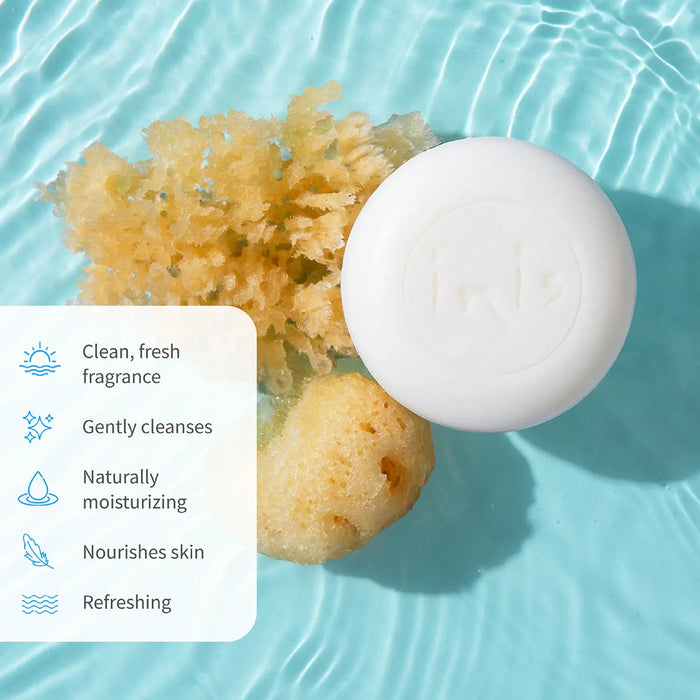 White round soap bar with natural sponge on a blue water background