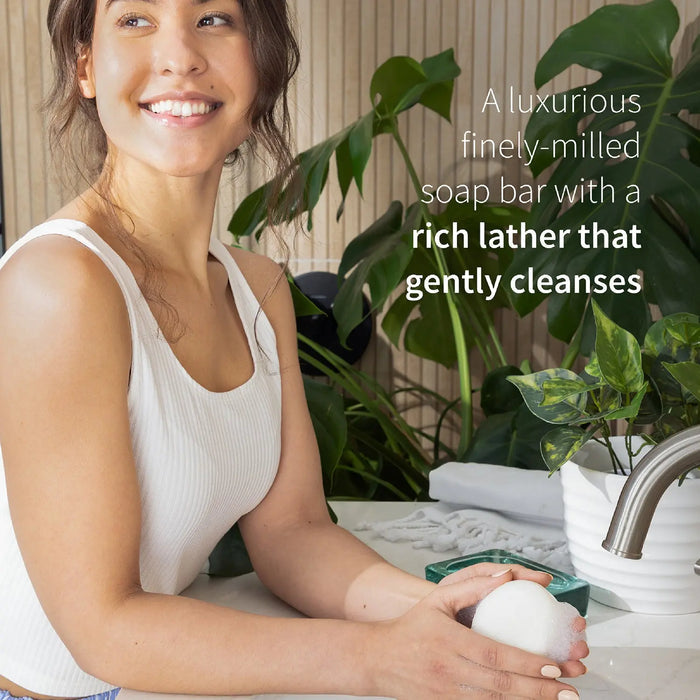 Woman holding a soap bar with text about a luxurious soap product
