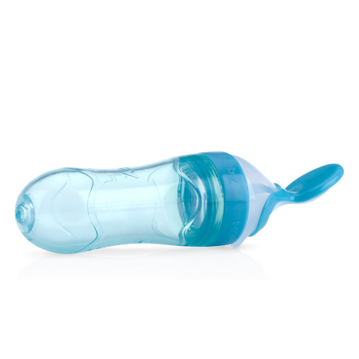 The Nuby Silicone Squeeze Feeder with Cover, a transparent blue silicone bottle with an attached spoon tip, is designed for convenient baby feeding.