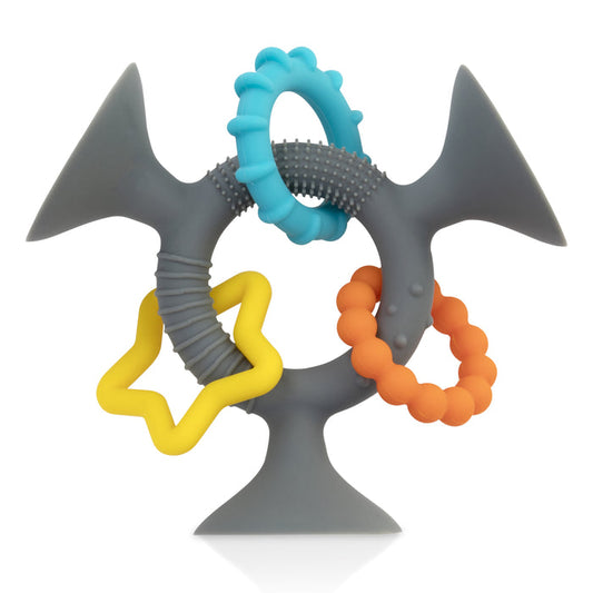 The Silly Suction Toy is a gray silicone baby teether featuring textured surfaces, two suction-cup ends, and colorful blue rings, yellow star, and orange bead shapes—ideal for infants to chew, grasp, and boost motor skills.