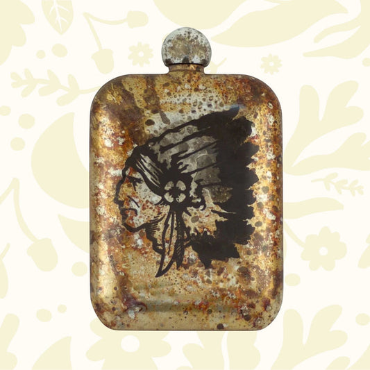 The Sneerwell Whiskey Flasks Chieftain features a rusty metal design with an engraved profile of a Native American chief head adorned with a feathered headdress, making it an ideal Father's Day gift that celebrates Native American culture.