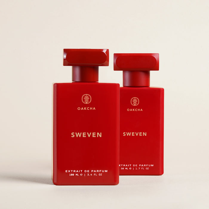 Front view of Sweven perfume: glossy red rectangular 100 mL bottle with Oakcha logo, 50 mL bottle behind on beige background