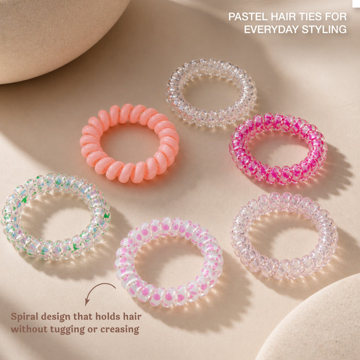 Set of colorful beaded hair ties on a textured beige surface with dried flowers.