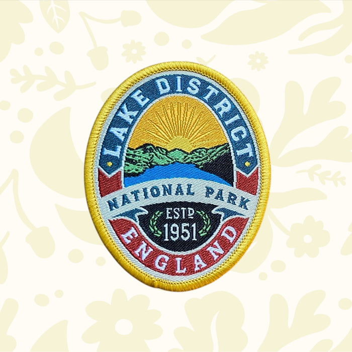 Lake District National Park Patch by Adventure Patch Company on wood, perfect hiking accessory for backpacks or outdoor gear.