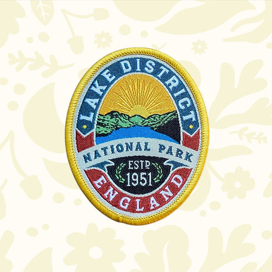 Lake District National Park Patch by Adventure Patch Company on wood, perfect hiking accessory for backpacks or outdoor gear.