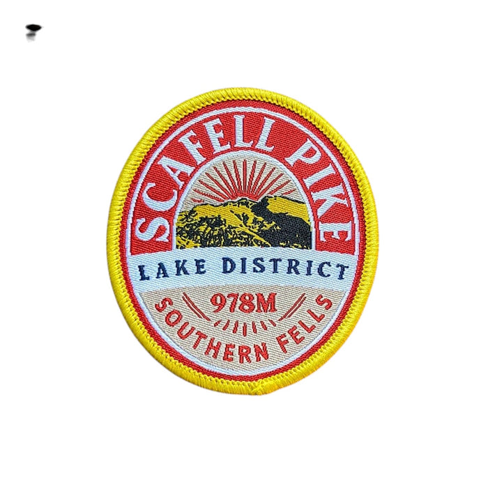 Forager Provisions LTD embroidered Scafell Pike patch featuring a mountain landscape design on a rustic wood surface.