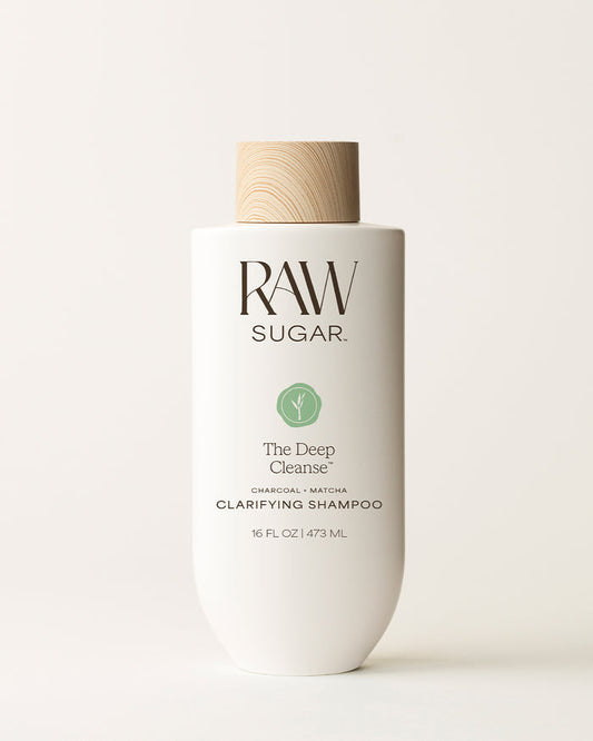Bottle of Raw Sugar Deep Cleanse Shampoo on a cream background, designed to help cleanse hair with clean ingredients.