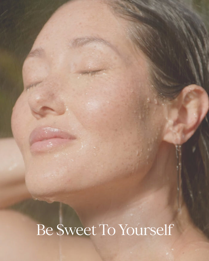 Woman with water droplets on her face with 'Be Sweet To Yourself' text