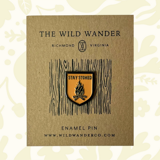 Forager Provisions LTD The Wild Wander Stay Stoked enamel pin featuring a campfire design on a gold-tone shield.