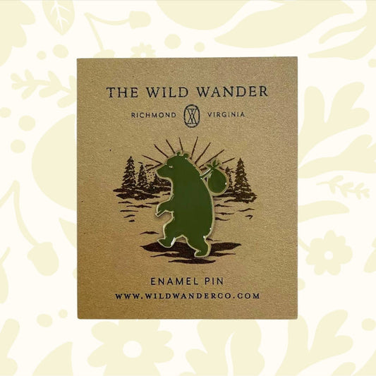 Forager Provisions LTD The Wild Wander green bear enamel pin on a branded backing card with forest illustration.