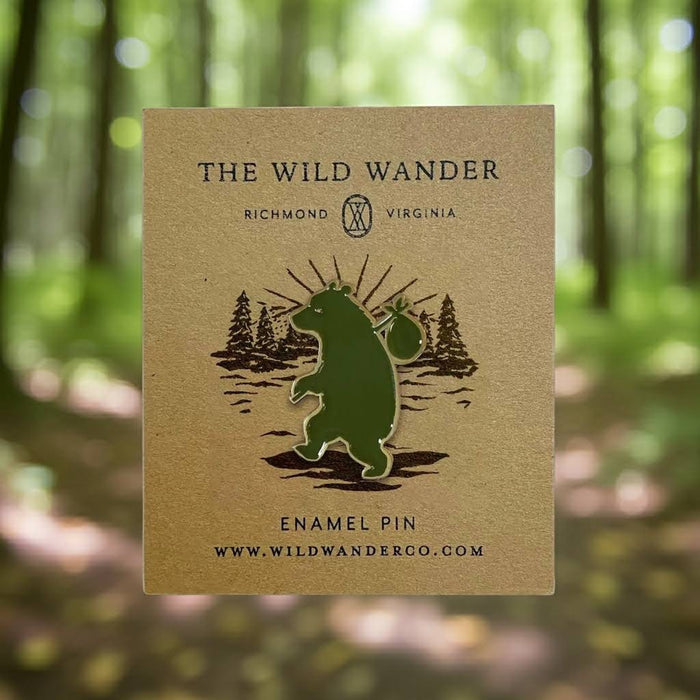 Forager Provisions LTD Wandering Bear enamel pin featuring a green bear on a branded backing card in a forest setting.