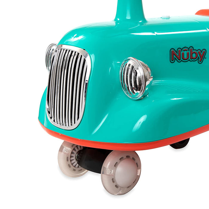 Close-up of the Twist N' Ride Classic Car in turquoise and orange, showcasing chrome headlights, a front grille, and light up wheels.