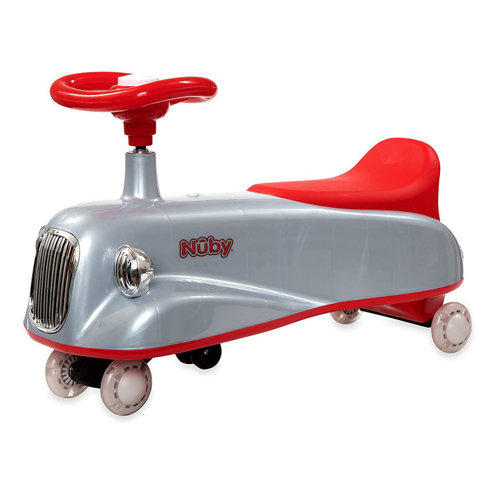 The Twist N’ Ride Classic Car for children features a silver and red design, a large red steering wheel, four light-up wheels, a chrome-like front grill, and the Nuby logo on the side.