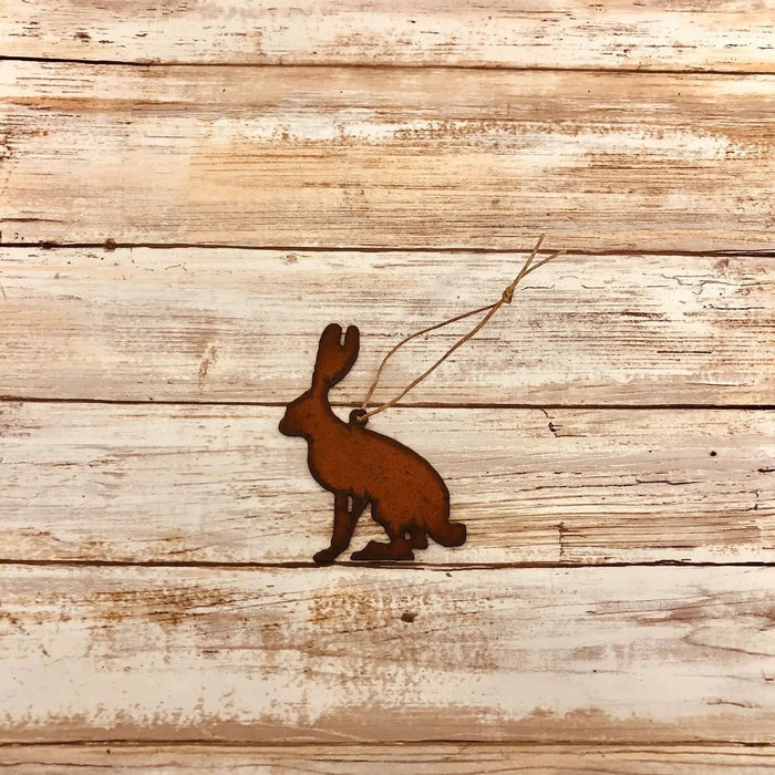 Universal Ironworks rust color Jack Rabbit hanging decoration displayed on a weathered wooden surface for rustic home décor.