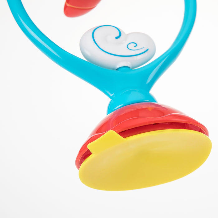 Close-up of the Whirly Wings interactive baby toy featuring a blue handle, white heart-shaped detail, red midsection, and large yellow suction base for sensory development, set against a white background.