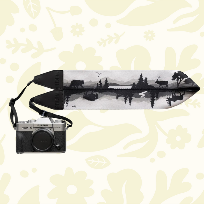 Forager Provisions LTD Wildtree camera strap featuring a black and white forest wildlife print attached to a camera.