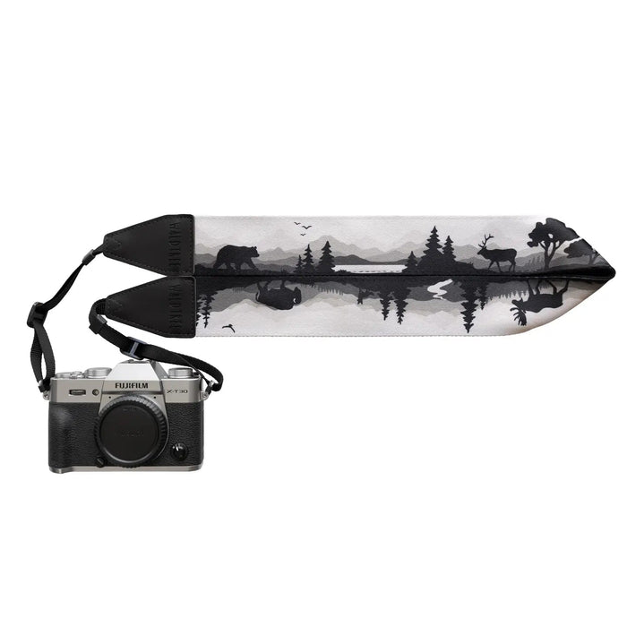 Forager Provisions LTD Wildtree camera strap featuring a black and white forest wildlife print attached to a camera