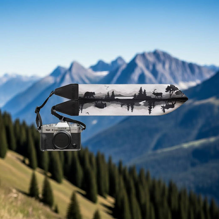 Forager Provisions LTD Wildtree camera strap featuring forest animal silhouettes against a mountain landscape backdrop.